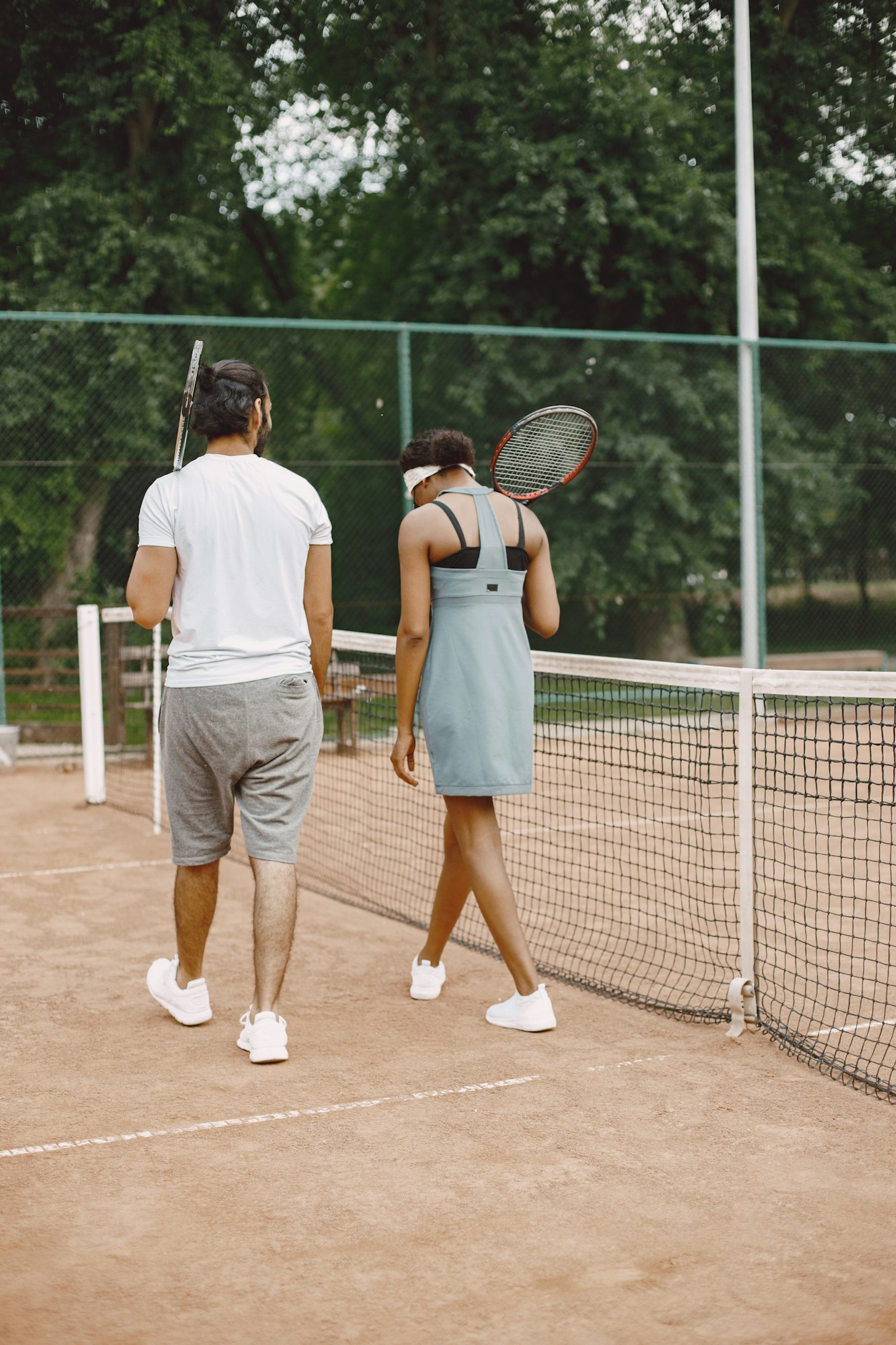 Two tennis players with rackets in hands after the match