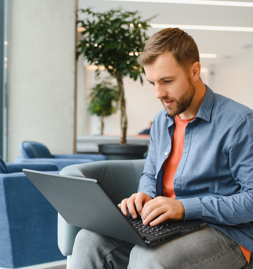 a freelancer man works with a laptop in a work coaching office