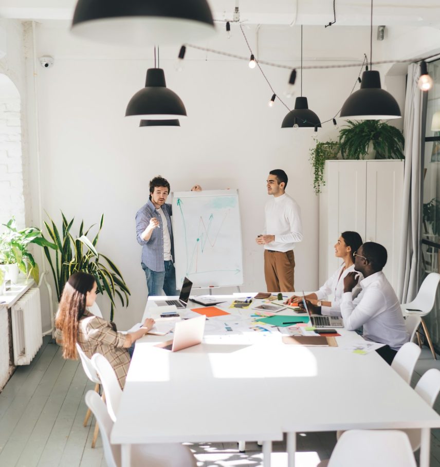 Male employees holding workshop to diverse colleagues